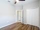 This bedroom features new flooring, a ceiling fan, and a closet with bright light at 13806 Reindeer Cir, Hudson, FL 34669