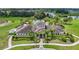 Beautiful clubhouse with palm trees, professional landscaping, and a community pool and water feature in a well-maintained community at 13806 Reindeer Cir, Hudson, FL 34669