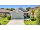 Charming single-Gathering home showcasing a well-maintained lawn and a two-car garage at 13806 Reindeer Cir, Hudson, FL 34669