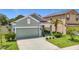 Charming home with well-maintained landscaping, a two-car garage, and green lawn at 13806 Reindeer Cir, Hudson, FL 34669