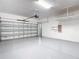 Spacious two-car garage with clean epoxy flooring and overhead storage racks at 13806 Reindeer Cir, Hudson, FL 34669