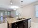 Open concept kitchen featuring an island with sink, stainless steel appliances at 13806 Reindeer Cir, Hudson, FL 34669