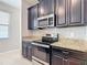 Modern kitchen with stainless steel oven, granite countertops, and ample storage space at 13806 Reindeer Cir, Hudson, FL 34669