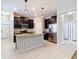 Spacious kitchen features stainless steel appliances, tile flooring, and an island with a patterned facade at 13806 Reindeer Cir, Hudson, FL 34669