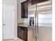 Close-up of stainless steel refrigerator, cabinets and granite countertops at 13806 Reindeer Cir, Hudson, FL 34669