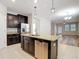 Kitchen with dark cabinets, stainless steel appliances, and a center island at 13806 Reindeer Cir, Hudson, FL 34669