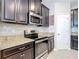 Stylish kitchen featuring stainless steel appliances and elegant countertops at 13806 Reindeer Cir, Hudson, FL 34669