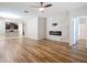 Open living room features modern fireplace, hardwood style floors and seamlessly connects to the kitchen at 13806 Reindeer Cir, Hudson, FL 34669
