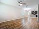 Bright living room with hardwood style floors offering a seamless flow into the kitchen area at 13806 Reindeer Cir, Hudson, FL 34669