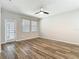 Bright, open-concept living room featuring wood flooring and a modern ceiling fan at 13806 Reindeer Cir, Hudson, FL 34669