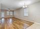 Open-concept living room with wood-style floors, neutral walls, ceiling fan, and natural light from windows at 13806 Reindeer Cir, Hudson, FL 34669
