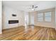 Comfortable living room with wood-style flooring, custom fireplace accent wall, and natural light from windows at 13806 Reindeer Cir, Hudson, FL 34669
