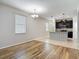 Bright room with hardwood floors that blends an open floor plan, seamlessly leading to the well-equipped kitchen at 13806 Reindeer Cir, Hudson, FL 34669