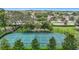 Community pickleball court has a green surface and is surrounded by mature shade trees at 13806 Reindeer Cir, Hudson, FL 34669