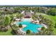 Aerial view of the community pool featuring plenty of lounge seating surrounded by lush greenery at 13806 Reindeer Cir, Hudson, FL 34669