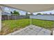 The back porch has a patio of square tiles and a white aluminum awning overlooking the yard at 1426 Gerard Ln, Holiday, FL 34690