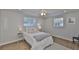 Cozy bedroom with a queen-size bed, ceiling fan, and natural light from two windows at 1426 Gerard Ln, Holiday, FL 34690