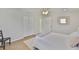 Bright bedroom features wood floors, a queen bed, closet and a doorway to another room at 1426 Gerard Ln, Holiday, FL 34690