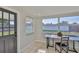 The breakfast nook has tiled floor, a window overlooking the back yard and a glass panelled door at 1426 Gerard Ln, Holiday, FL 34690