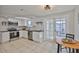 Updated kitchen features white cabinets, subway tile backsplash, stainless steel appliances, and wood counters at 1426 Gerard Ln, Holiday, FL 34690