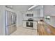 Beautiful kitchen features stainless steel appliances, wood counters, and ample cabinet space at 1426 Gerard Ln, Holiday, FL 34690