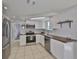 Modern kitchen features subway tile backsplash, stainless steel appliances, and wood counters at 1426 Gerard Ln, Holiday, FL 34690