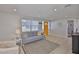 Open concept living room with tile flooring, neutral walls, and bright yellow front door at 1426 Gerard Ln, Holiday, FL 34690
