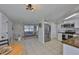 Open layout connects the living room and updated kitchen with stainless appliances at 1426 Gerard Ln, Holiday, FL 34690