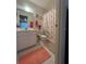 Functional bathroom with a single sink vanity, framed mirror, and shower with patterned curtain at 1448 Highland Ridge Cir, Brandon, FL 33510