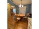 The dining room has a chandelier and seating for four, with a wood cabinet in the background at 1448 Highland Ridge Cir, Brandon, FL 33510