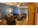 Comfortable living room featuring cozy couches, a ceiling fan, and sliding glass doors for natural light at 1448 Highland Ridge Cir, Brandon, FL 33510