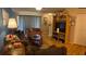 Inviting living room with a sofa, wooden entertainment center, and sliding doors that let in ample light at 1448 Highland Ridge Cir, Brandon, FL 33510