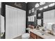 Stylish bathroom with dark gray walls, featuring a single vanity and a neatly organized linen area at 15206 Merlinpark Pl, Lithia, FL 33547