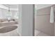 Bright bathroom with a soaking tub and tiled shower, creating a spa-like atmosphere at 15206 Merlinpark Pl, Lithia, FL 33547