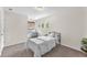 Cozy bedroom featuring a black metal bed, side tables, and soft natural light from the window at 15206 Merlinpark Pl, Lithia, FL 33547