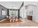 Open-concept dining area with wood floors and elegant chandelier lighting at 15206 Merlinpark Pl, Lithia, FL 33547