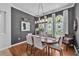 Charming dining room with hardwood floors, large windows, and neutral color scheme at 15206 Merlinpark Pl, Lithia, FL 33547