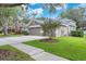 Charming exterior of a well-maintained home with a landscaped front yard and a two-car garage at 15206 Merlinpark Pl, Lithia, FL 33547