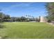 Green lawn space with a building in the background, with a splash fountain, and trees at 15206 Merlinpark Pl, Lithia, FL 33547