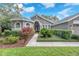 Inviting home exterior featuring lush landscaping and a welcoming walkway at 15206 Merlinpark Pl, Lithia, FL 33547
