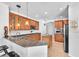 Traditional kitchen with brown cabinets, granite countertops, a kitchen island, and stainless steel appliances at 15206 Merlinpark Pl, Lithia, FL 33547