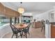 Open-concept living room and eat-in kitchen boasting natural light from the large windows and sliding doors at 15206 Merlinpark Pl, Lithia, FL 33547