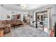 Inviting open-concept living room with an area rug and views of the backyard pool area at 15206 Merlinpark Pl, Lithia, FL 33547