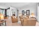 Cozy living room with tan leather furniture and an open layout at 15206 Merlinpark Pl, Lithia, FL 33547