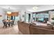 Open-concept living room with the eat-in kitchen and a view of the backyard pool at 15206 Merlinpark Pl, Lithia, FL 33547