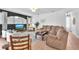 Comfortable open concept living room featuring a large sofa and dark accent wall at 15206 Merlinpark Pl, Lithia, FL 33547