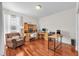 Spacious home office with hardwood floors, multiple workstations, and abundant natural light at 15206 Merlinpark Pl, Lithia, FL 33547