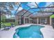 A screened-in pool and lounge area with sleek outdoor furniture at 15206 Merlinpark Pl, Lithia, FL 33547