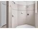 Modern bathroom showing tiled shower stall with updated fixtures and a crisp, clean design at 15206 Merlinpark Pl, Lithia, FL 33547