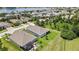 Aerial view of a single-Gathering home with a screened lanai surrounded by a lush green lawn at 1846 Moorhen Way, Lutz, FL 33558